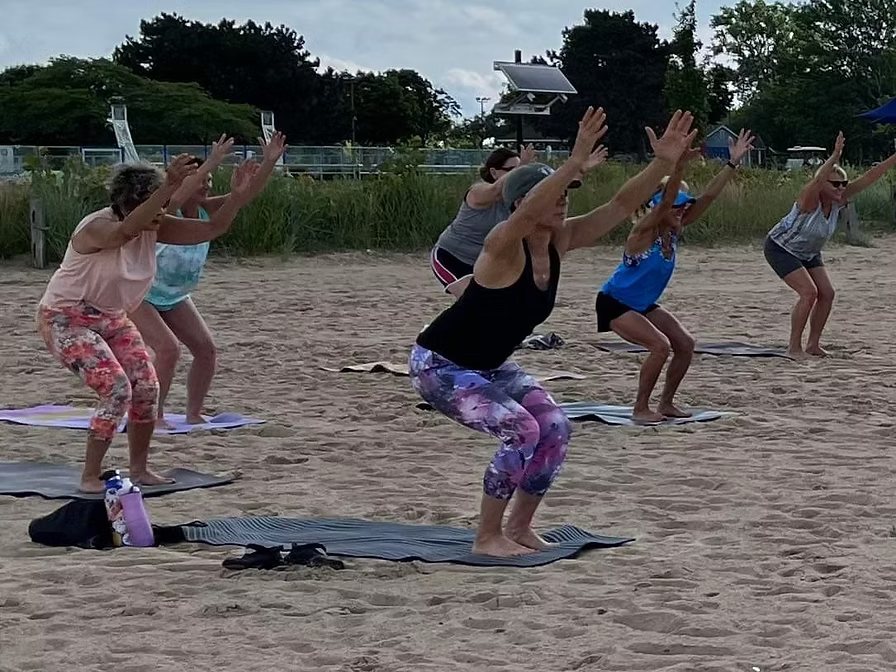 Group yoga session on the beach