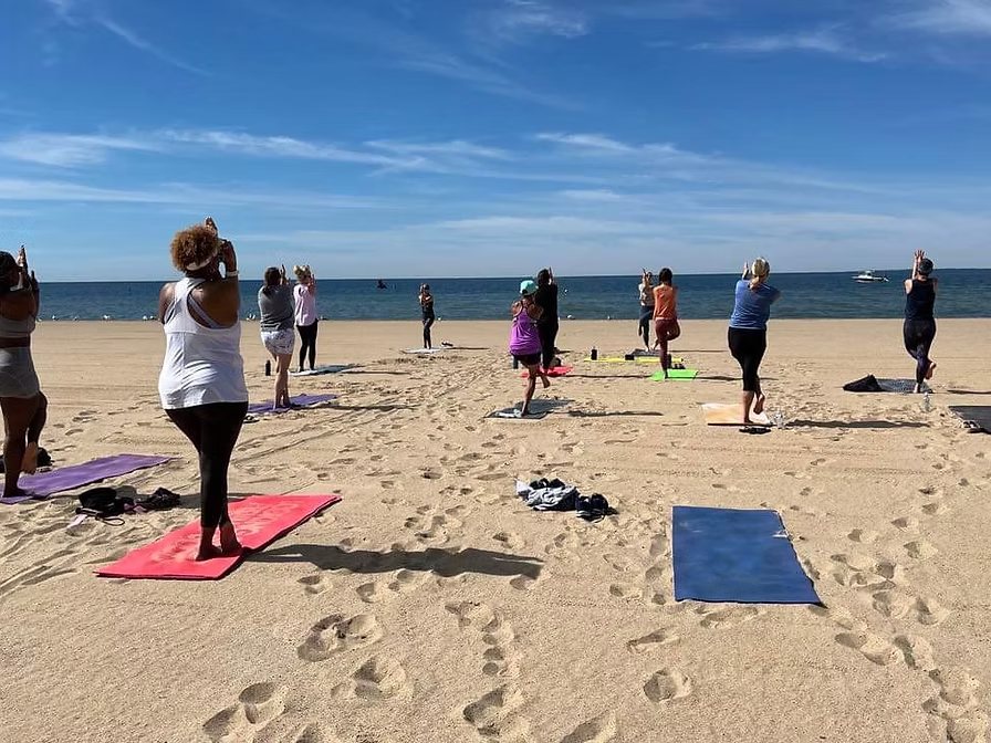 Two practitioners in beach yoga